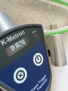 Picture of a K-Metron measuring a foamed roto part, measuring 9.8mm thickness.